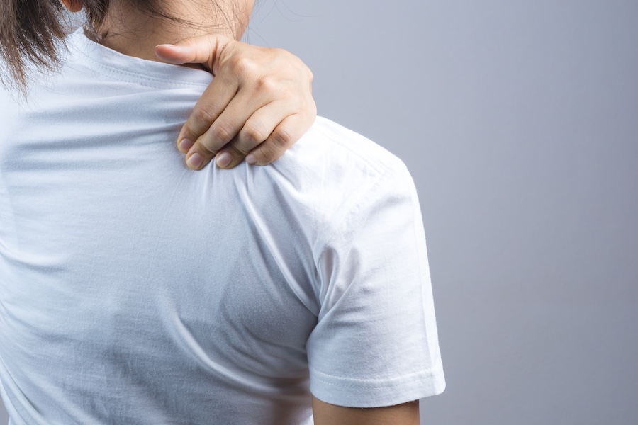 Woman putting her hand for neck and shoulder pain