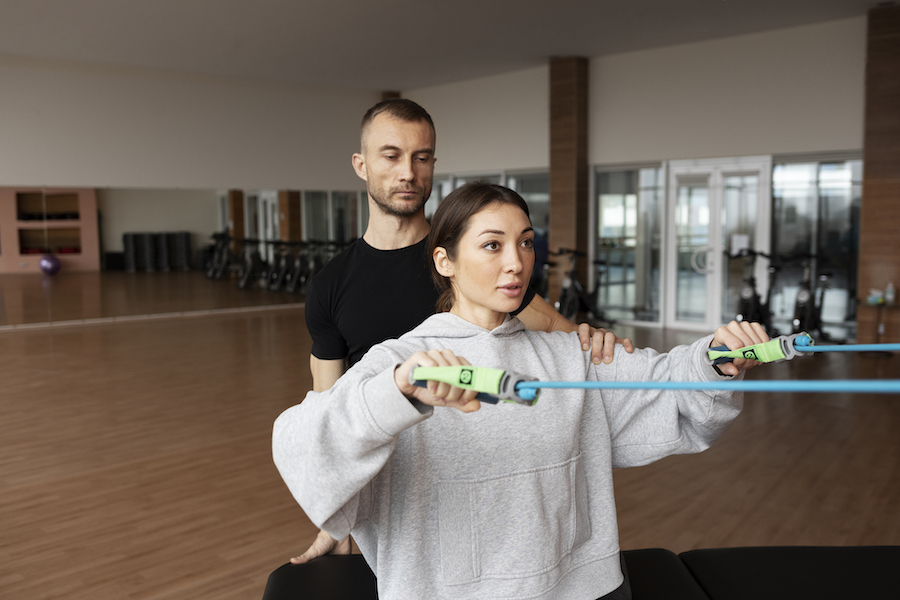 patient-doing-physical-rehabilitation-helped-by-therapists (1)
