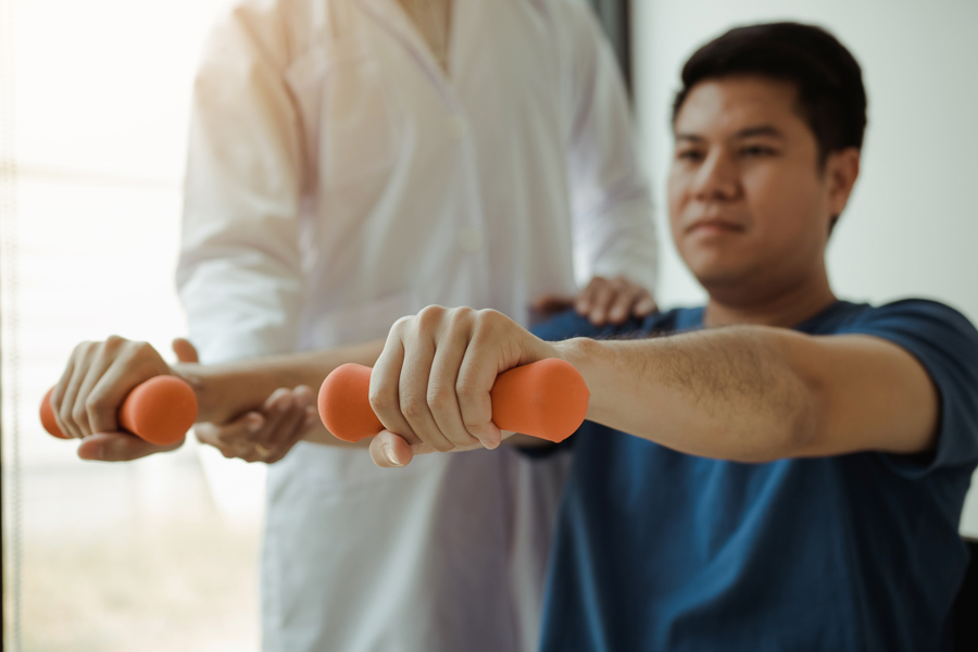 midsection-trainer-helping-man-doing-exercise